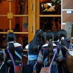 Hmong girls gather outside a restaurant to watch TV in Sapa. -- CAROLINE CHIA/THE STRAITS TIMES